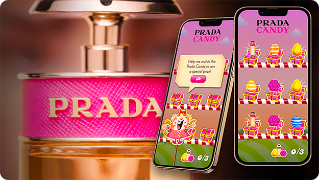 Close-up of a pink Prada perfume bottle on the left, with two smartphones on the right showing a Prada Candy-themed matching game featuring colorful candy icons and a prize message.