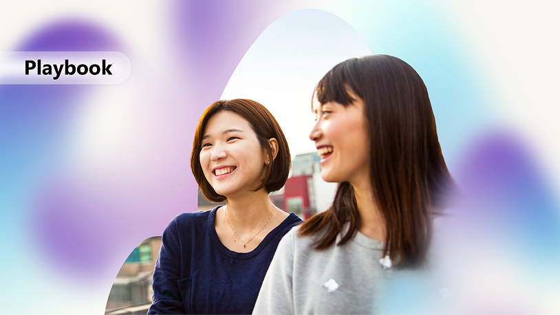 The image depicts two people with their backs to each other, wearing casual attire, against a blurred, colorful background.