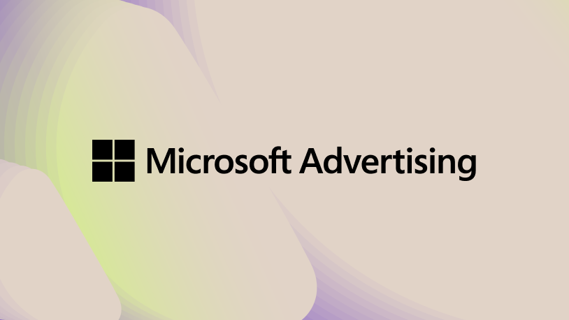 Three friends smile and embrace while taking a selfie outdoors on a sunny day, with green trees and grass in the background.